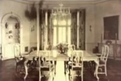 A dining room with a table and chairs in it