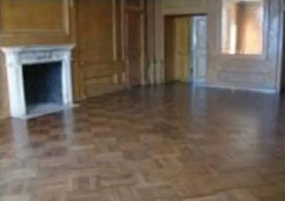 A room with wood floors and fireplace in it