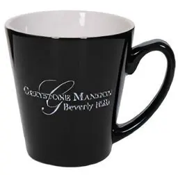 A black coffee mug with the name of cameron mansion and beverly hills.