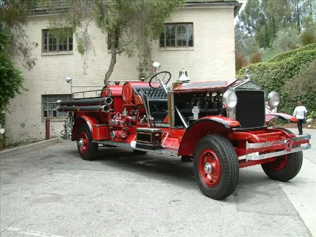 A red fire truck parked in front of a building.